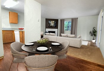Open layout dining room between kitchen and living room. Contains round dining table and 4 chairs. Living room in background contains large sofa, window and corner fireplace.